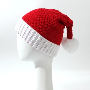 Classic red and white knitted Christmas hat with pompom on a display mannequin
