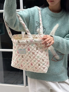 Detailed shot of quilted tote bag with cute bear and rabbit patterns on cotton fabric