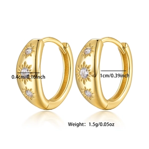 Detail of s925 silver gold earrings with sunburst pattern and cubic zirconia inlay