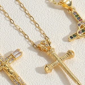 Detailed macro view of vintage hollow cross pendants with colorful zircon inlay