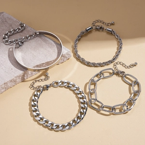 Set of four silver geometric chain bracelets with curb, rope, and oval link textures