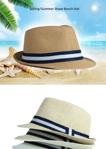 Detail of woven straw fedora hats with nautical striped bands for beach wear