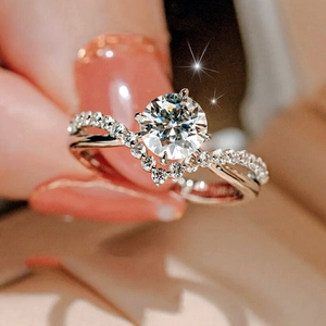 Macro detail of silver engagement ring with V-shaped pavé band and round centerpiece