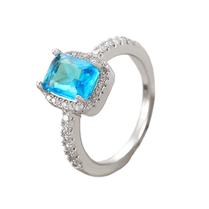 Macro shot of rectangular blue zircon ring with sparkling pave stones on silver band