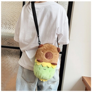 Back view of a cute capybara plush crossbody bag with green and yellow accents on a model
