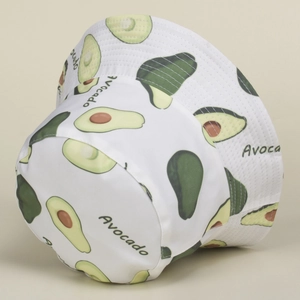 Detail of white canvas bucket hat featuring green avocado print and text patterns