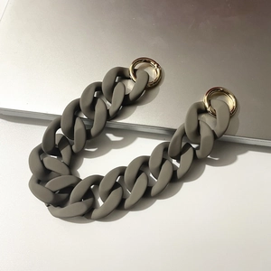 Detail of grey frosted resin thick chain strap with golden round spring buckles