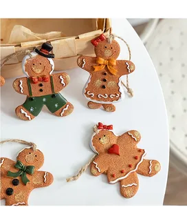 Detail view of four resin gingerbread man ornaments with sugar texture and jute ropes