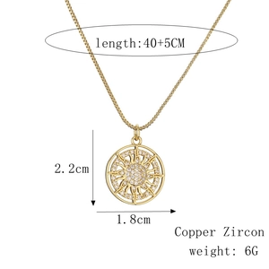Detail view of gold sun pendant with measurements and copper zircon material specs
