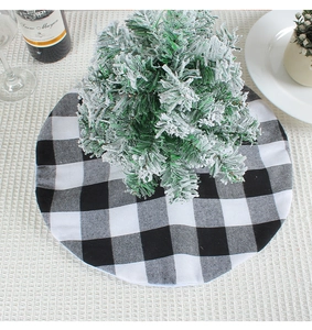 Detailed top view of classic black and white buffalo plaid Christmas tree skirt on a table