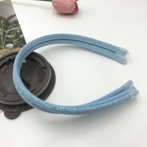 Close-up of light blue sequined double headband with protective tips on white background
