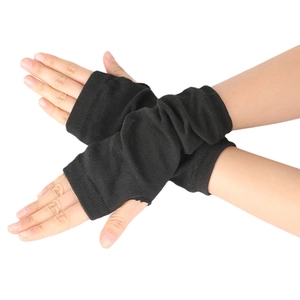Close-up of black knitted fingerless wrist warmers with elastic ribbed texture