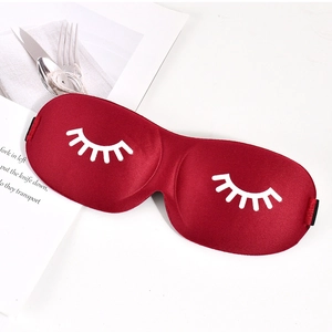 Detail of red 3D eyelash sleep mask with silky texture and white printed graphics