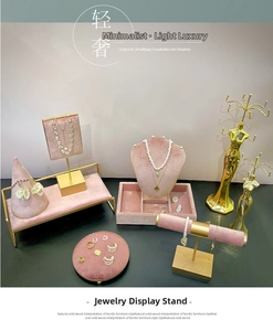 Detailed set of pink velvet and gold metal jewelry displays for necklaces and rings