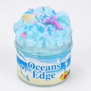 Ocean Edge blue cloud slime with dolphin and shell charms in a clear jar