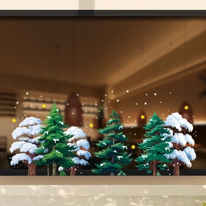 Christmas window stickers featuring white snow cedar trees and yellow stars on glass