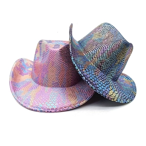 Macro detail of metallic snake-print texture on colorful western cowboy party hats