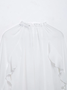 Detail view of the elegant white chiffon shirt showing ruffled high collar and soft texture