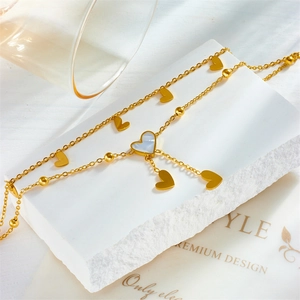 Gold layered heart necklace with mother of pearl pendant and beaded chain design