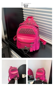 Detail of rose red mini backpack with silver rivets, cross charm and chain accent