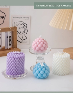 Detail of colorful bubble and pillar scented candles in a cozy home decor setting