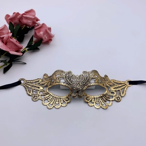 Detailed embroidery of gold lace masquerade mask with delicate floral patterns