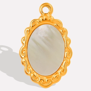 Detailed close-up of oval stainless steel pendant with white mother of pearl and gold carving