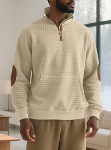 Detail of men's beige waffle knit sweatshirt with elbow patches and half-zip collar
