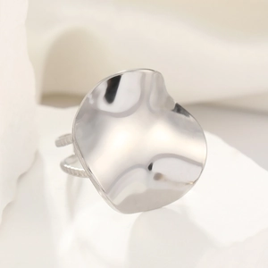 Macro shot of silver pleated titanium steel ring with irregular wavy surface and double band