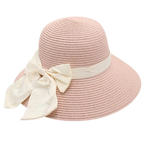 Close-up of the fine straw weave and cream ribbon bow on this pink sun hat for women