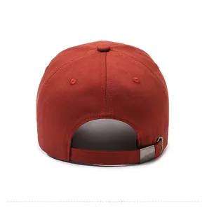 Detail view of brick red cotton baseball cap with adjustable metal buckle strap
