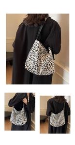Detailed close-up and lifestyle view of a leopard print canvas shoulder bag with black strap