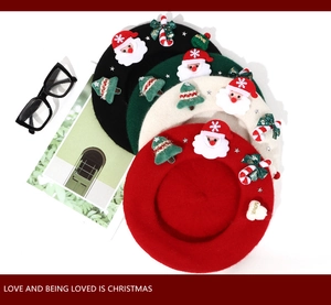 Flat lay of wool berets in four colors with festive Christmas embroidery and text