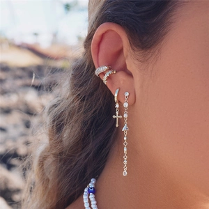 Detail view of S925 silver fringe earrings and diamond ear cuffs worn by a model