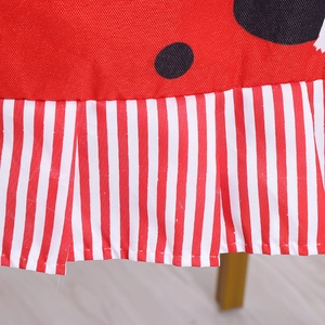 Christmas chair cover featuring red black polka dots and festive striped pleated borders
