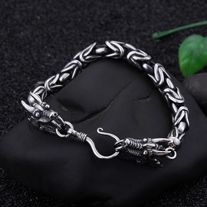 Macro detail of men's Byzantine chain bracelet with vintage steel dragon heads and S-hook