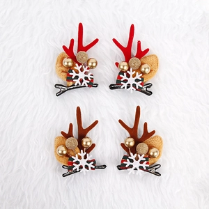 Christmas reindeer antler hair clips set with festive bells and striped bows on white fur