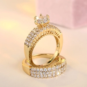 Detailed macro view of a luxury gold ring set featuring sparkling zircon stones and pavé setting