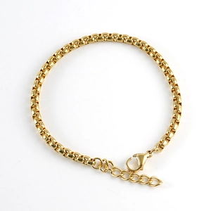 Detailed close-up of golden stainless steel box chain bracelet with lobster clasp closure