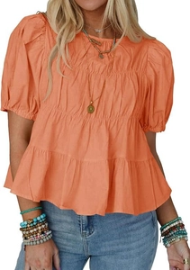 Detail of coral puff sleeve blouse showing ruffled layered hem and cotton texture