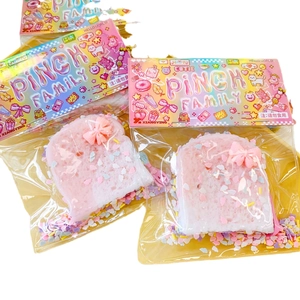 Pink toast-shaped PINCH FAMILY squishy stress toy with colorful sprinkles in packaging