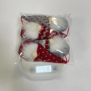 Set of 4 Christmas gnomes with knitted hats and white beards on a digital weight scale