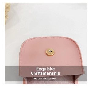 Detail view of pink leather bag featuring high-quality stitching and a golden magnetic buckle