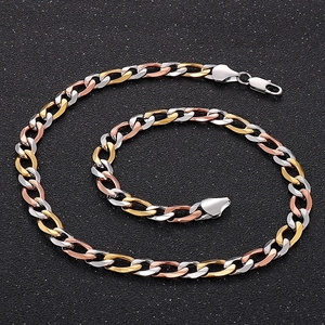 Macro view of two-tone stainless steel Cuban chain necklace with a lobster clasp