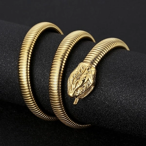 Detailed view of golden multi-wrap snake bracelet on black stand with spiral texture