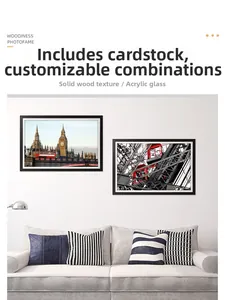 Detail of modern black wooden photo frames with white mat hanging on a minimalist wall