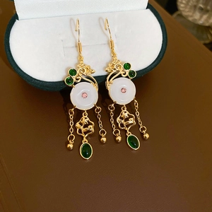 Classic Chinese style gold earrings with white jade donut and green tassel details