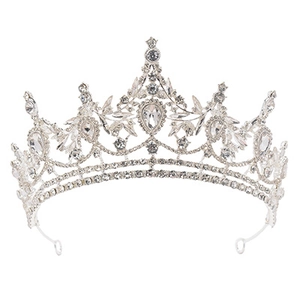Macro view of silver bridal crown with intricate metal scrollwork and crystal rhinestones
