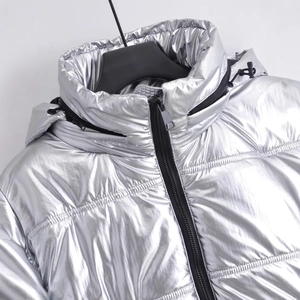 Women's metallic silver hooded puffer jacket with black zipper and drawstring details