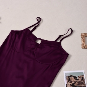 Detail of dark purple satin slip dress with adjustable straps and front hollow cutout